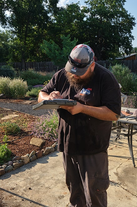 a member of chico septic writing on a clip board